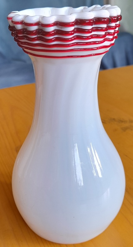 white Victorian vase with red trailing