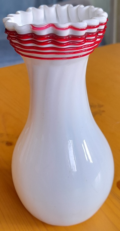white Victorian vase with red trailing
