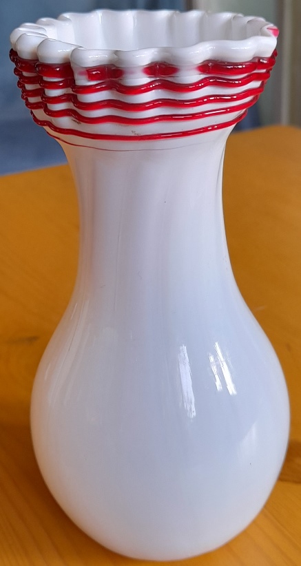 white Victorian vase with red trailing