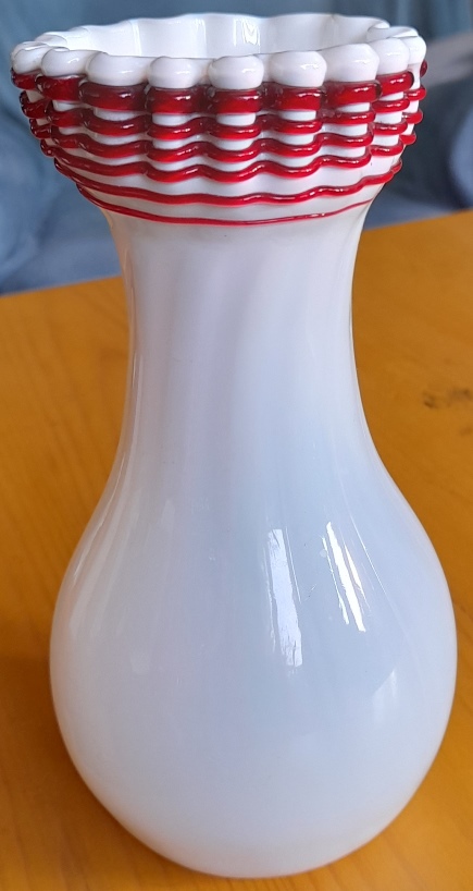 white Victorian vase with red trailing