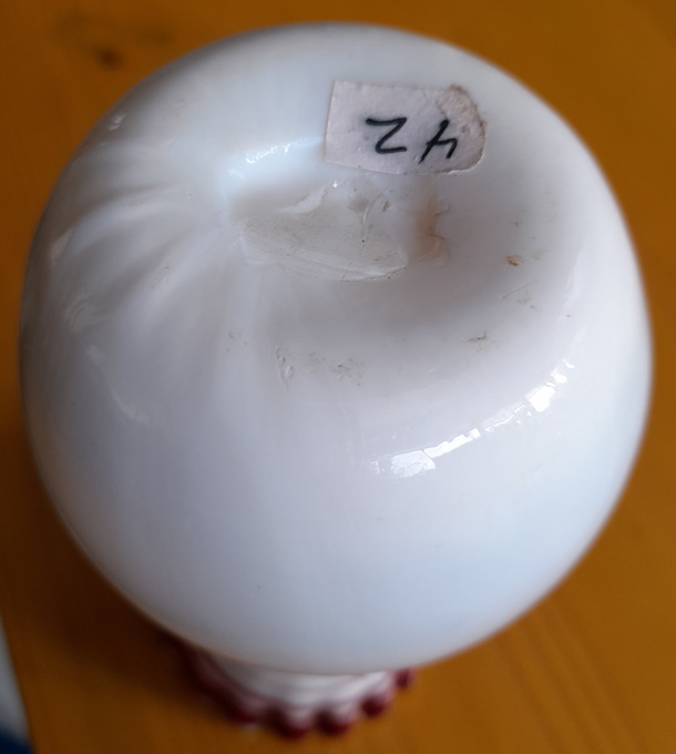 white Victorian vase with red trailing