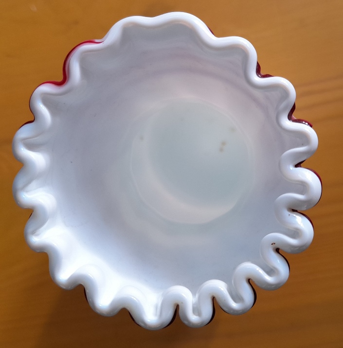 white Victorian vase with red trailing